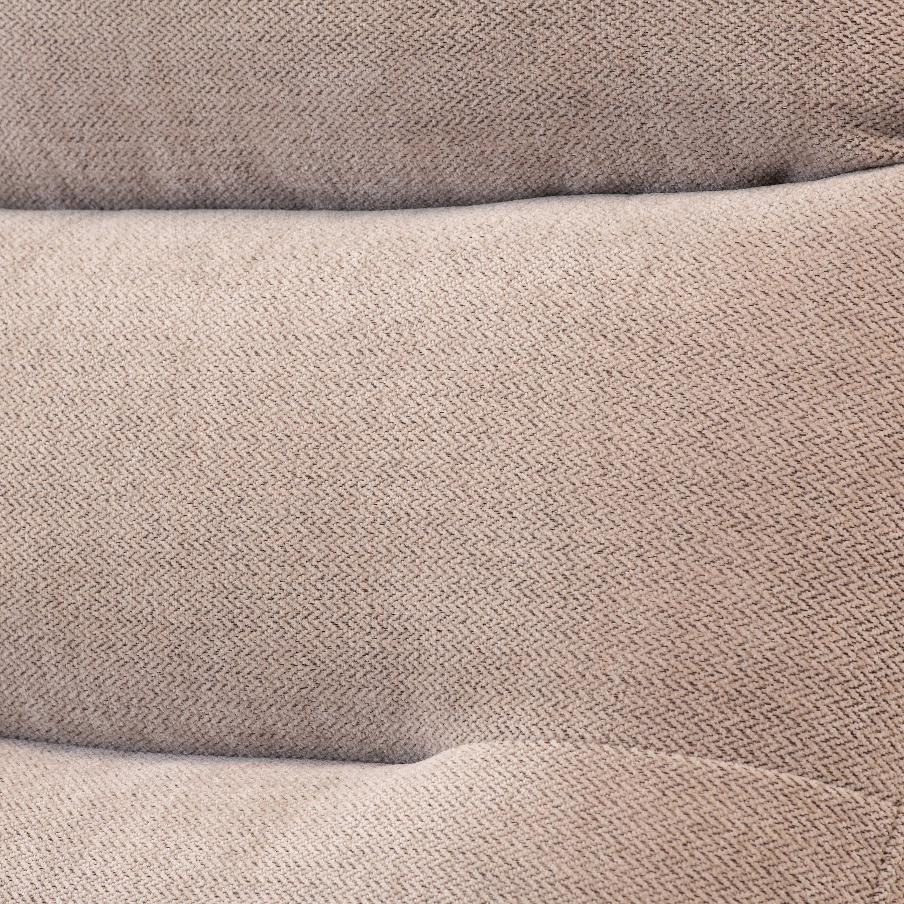 Three stacked, brown textured pillows with a zigzag pattern, resting against each other.