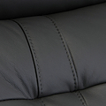 Black leather texture with visible stitching detail, creating a pattern of upholstered segments; likely from furniture such as a couch or car seat.