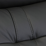 Black leather texture with visible stitching detail, creating a pattern of upholstered segments; likely from furniture such as a couch or car seat.