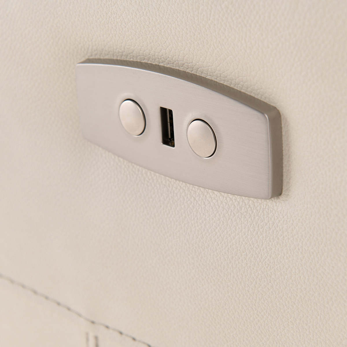 A dual USB port is mounted on a textured beige wall, providing a charging point in a modern interior setting.