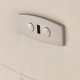 A dual USB port is mounted on a textured beige wall, providing a charging point in a modern interior setting.
