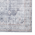 A vintage-style rug with intricate patterns and faded colors, predominantly in shades of gray and beige, rests against a white backdrop.