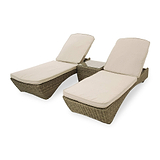 Two wicker sun loungers with beige cushions, positioned side by side, isolated on a white background.