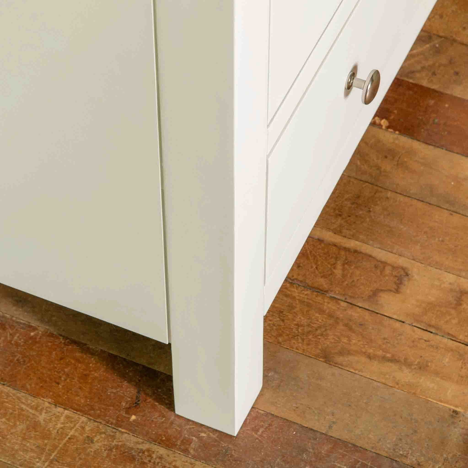 Close up of front leg on The Cornish White Wooden Chest of Drawers 
