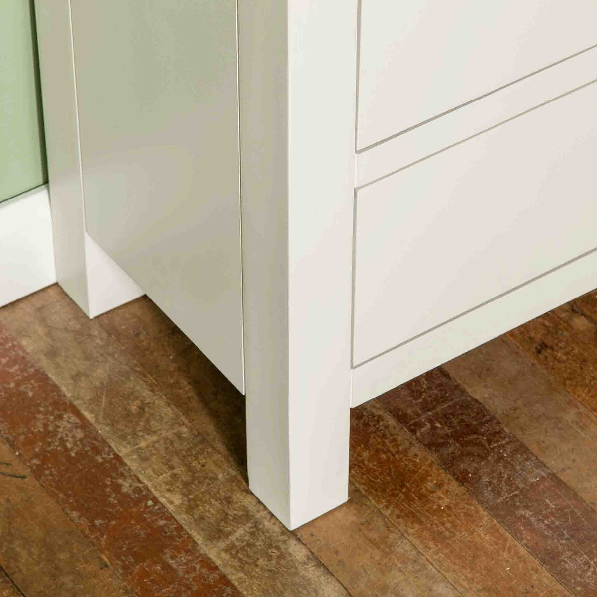 Close up of leg on The Cornish White Wooden Chest of 6 Drawers