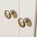 Close up of metal door knobs on The Cornish White Wooden Double Wardrobe