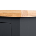 A wooden plank rests atop a black drawer unit, secured with a bandage where the wood is split at the edge.