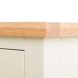 A wooden table edge with a beige adhesive bandage, set against a white background suggesting a simplistic or clinical environment.