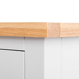 A wooden plank with a bandage, suggesting repair, against a white background with a blurred gray drawer unit beneath.
