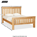 A wooden bed with two pillows, dimensions marked as 195cm wide, 114cm high, and 217cm long. Logo: Roseland Furniture. Text: "Image for size information only."