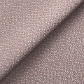 Textured fabric with a folded edge, revealing the pattern and weave structure, cast in soft light.