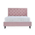 A pink tufted headboard attached to a matching platform bed frame with a white mattress on top, isolated against a white background.
