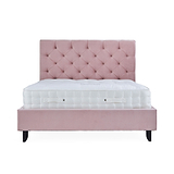 A pink tufted headboard attached to a matching platform bed frame with a white mattress on top, isolated against a white background.