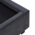 A dark gray upholstered sofa corner against a plain background, with focus on its clean lines and fabric texture; no evident action or additional context.