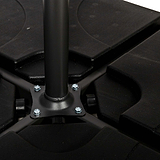 A cylindrical black metal pole is mounted to a five-armed plastic base with bolts, possibly part of an office chair. The background is white.