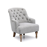 A tufted gray armchair with wooden legs stands idle, isolated against a white background.
