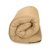 A beige bean bag chair is placed against a white background, with a deep crease at its center suggesting a soft and malleable structure.