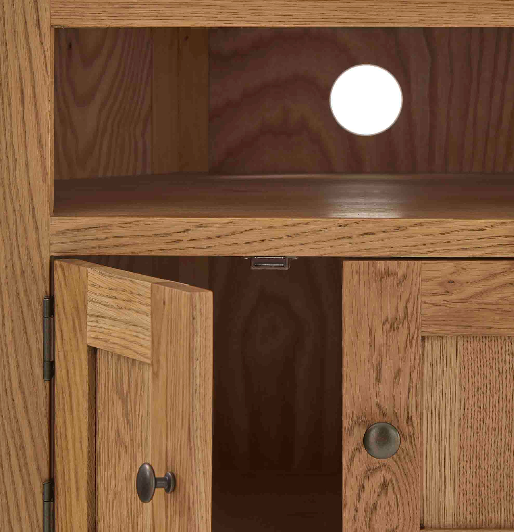 Zelah Oak Corner TV Stand - Close up of cable access hole in back 