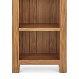 Zelah Oak Narrow Bookcase - Close up of lower shelves and feet on bookcase