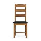 Wooden chair with black cushioned seat and ladder-style back.