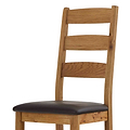 Wooden chair with dark brown leather seat and ladder-back design.