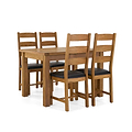 A wooden dining table and four chairs with black cushioned seats, arranged in an orderly fashion against an isolated white background.