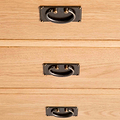 close up of brass drawer handles on the Surrey Oak 3 over 3 Chest Of Drawers