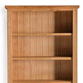 A simple wooden bookshelf with three shelves, empty, against a white background.