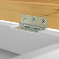A metal hinge connects a wooden piece to a white surface, illustrating the hardware in use within a simple, clean environment.