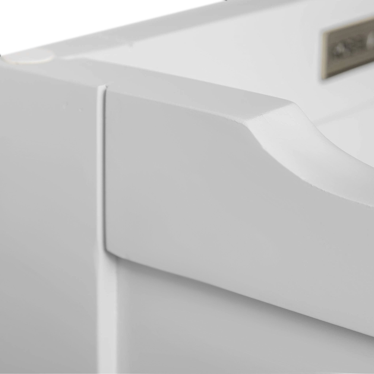 A close-up of a white, textured object with a curved edge, against a blurred background, possibly part of furniture or appliance.