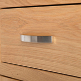 close up of contemporary metal handle on the London Oak Mini Sideboard by Roseland Furniture. 