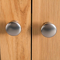 close up of metal round door knobs on the London Oak Mini Sideboard by Roseland Furniture. 