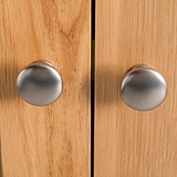 close up of metal round door knobs on the London Oak Mini Sideboard by Roseland Furniture. 