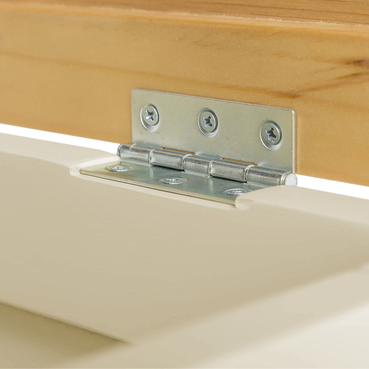 A metal hinge connects two pieces of wood, facilitating pivot motion, set against a blurred background.
