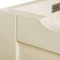 A close-up of a beige object with smooth curves and a rectangular label or emblem, possibly a part of plastic machinery or equipment, against a neutral background.
