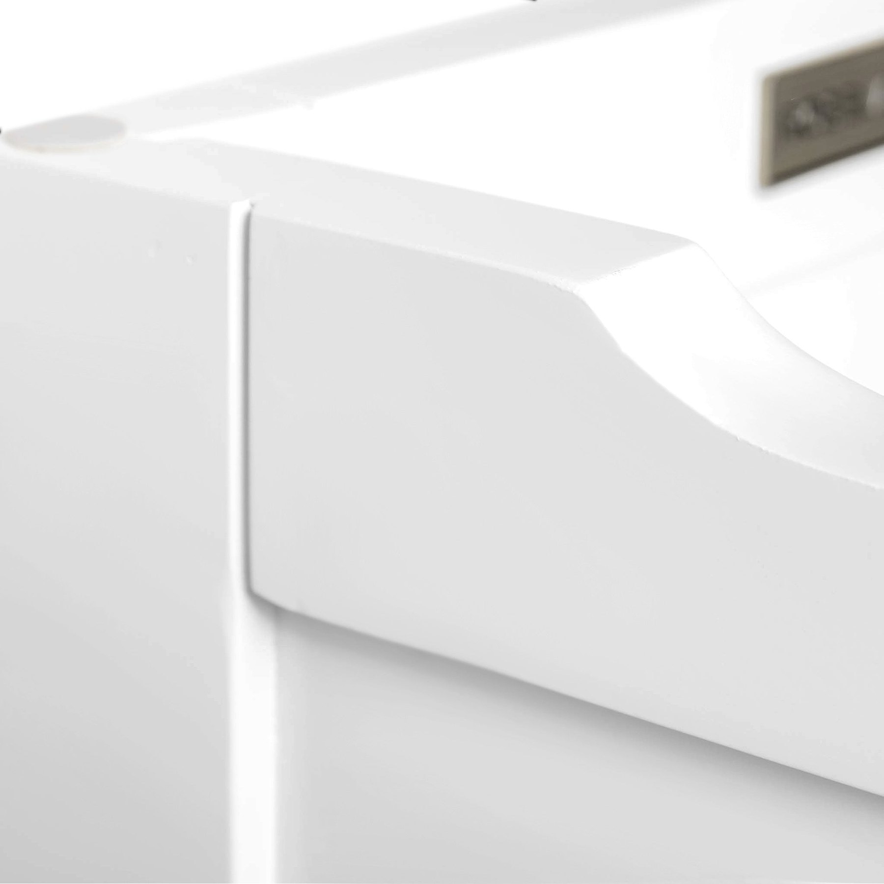 A close-up of a white, curved bathtub edge with a blurred background, conveying a clean and modern bathroom aesthetic. There is no text in this image.