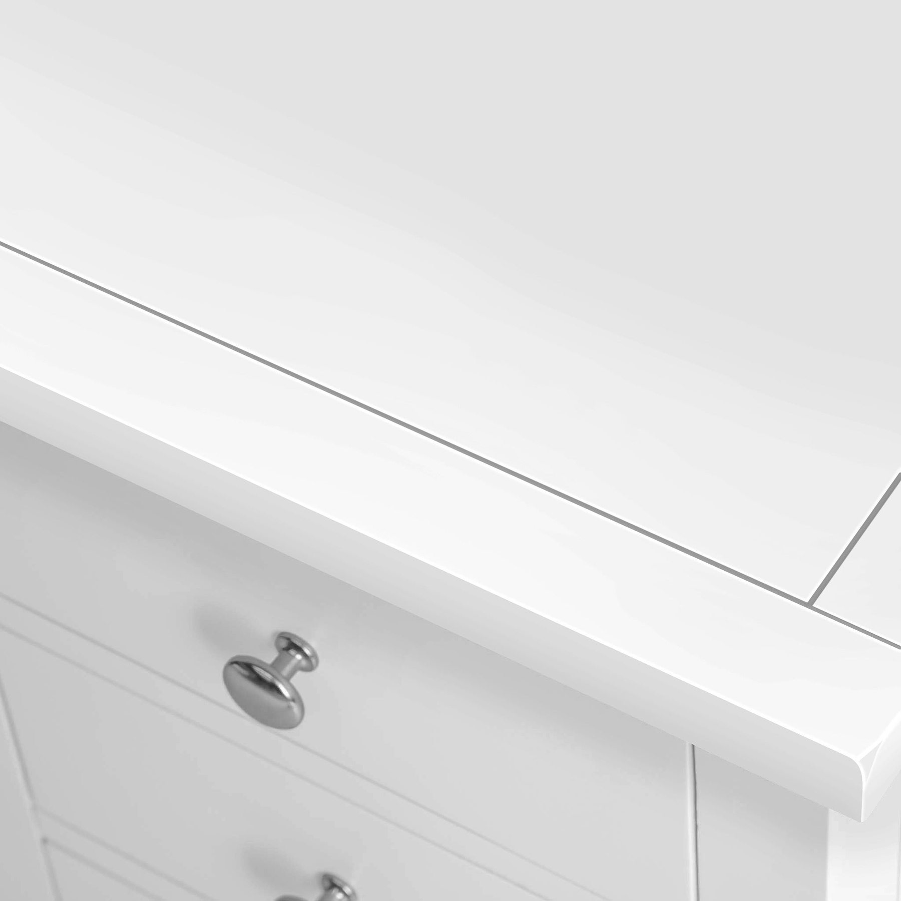 A white bathroom vanity with a closed drawer and silver knob, set against a plain background.