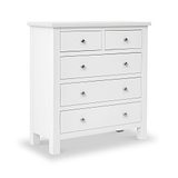A white wooden dresser with seven drawers, each featuring a simple round knob, stands isolated against a plain background.