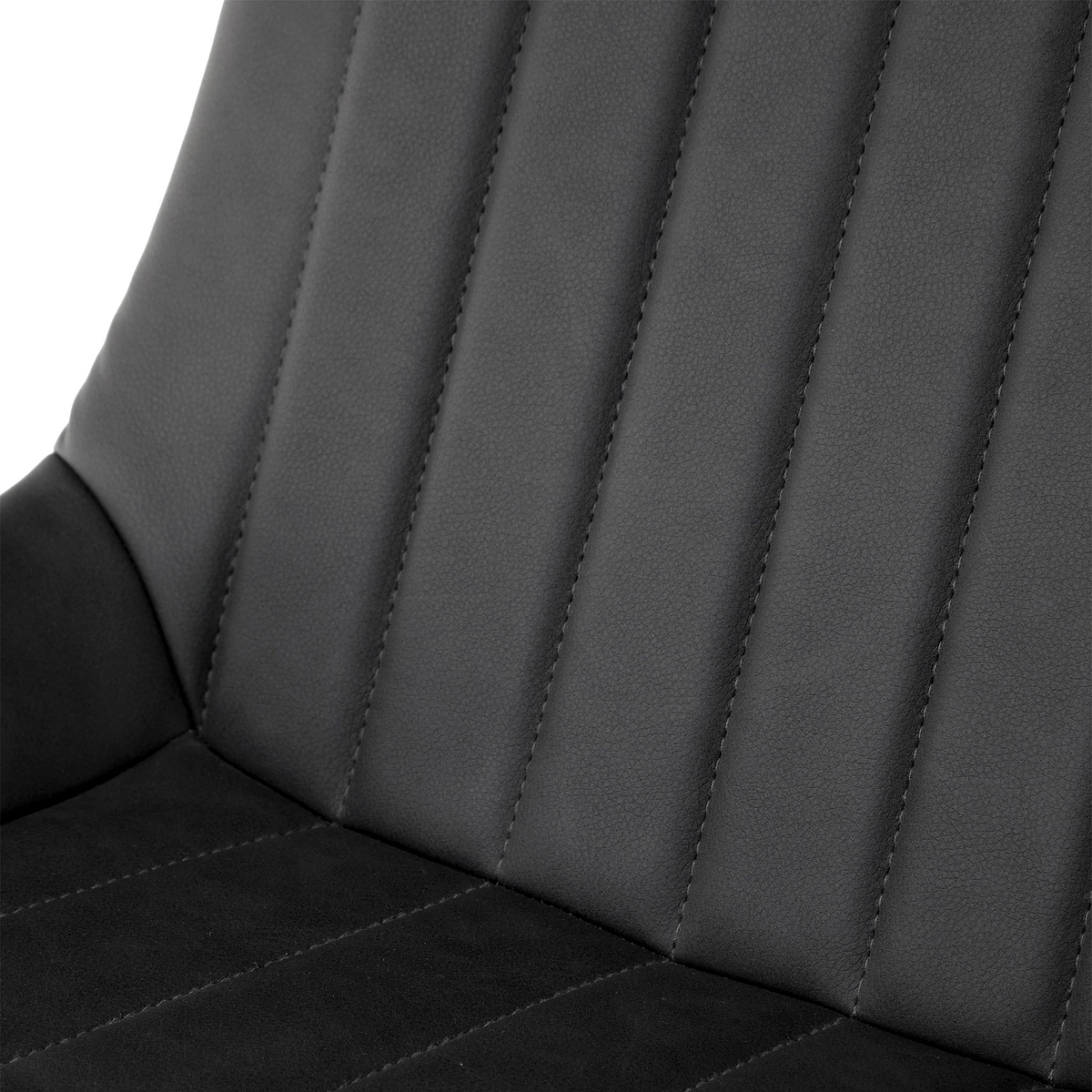 A close-up view of a black, faux-leather car seat with stitched vertical lines, against a nondescript background.