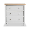 A white three-drawer chest with a natural wood top and round silver knobs on a plain background.