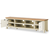A two-tone wooden TV stand with open shelves and two cabinets on a white background, one cabinet door is ajar illustrating the interior.