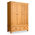 A wooden wardrobe stands against a white background, featuring two doors and a lower section with two drawers, all with round knobs.