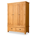 A wooden wardrobe with three doors above two drawers stands isolated against a white background.