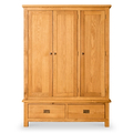 A wooden wardrobe with two doors above a drawer, standing against a white background.