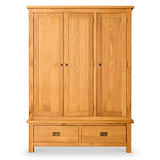 A wooden wardrobe with two doors above a drawer, standing against a white background.