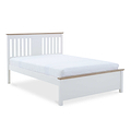 A white wooden bed frame with slatted headboard supports a mattress, against a stark white background.