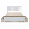A white wooden bed frame with a slatted base and a headboard, featuring under-bed storage drawers, isolated on a white background.