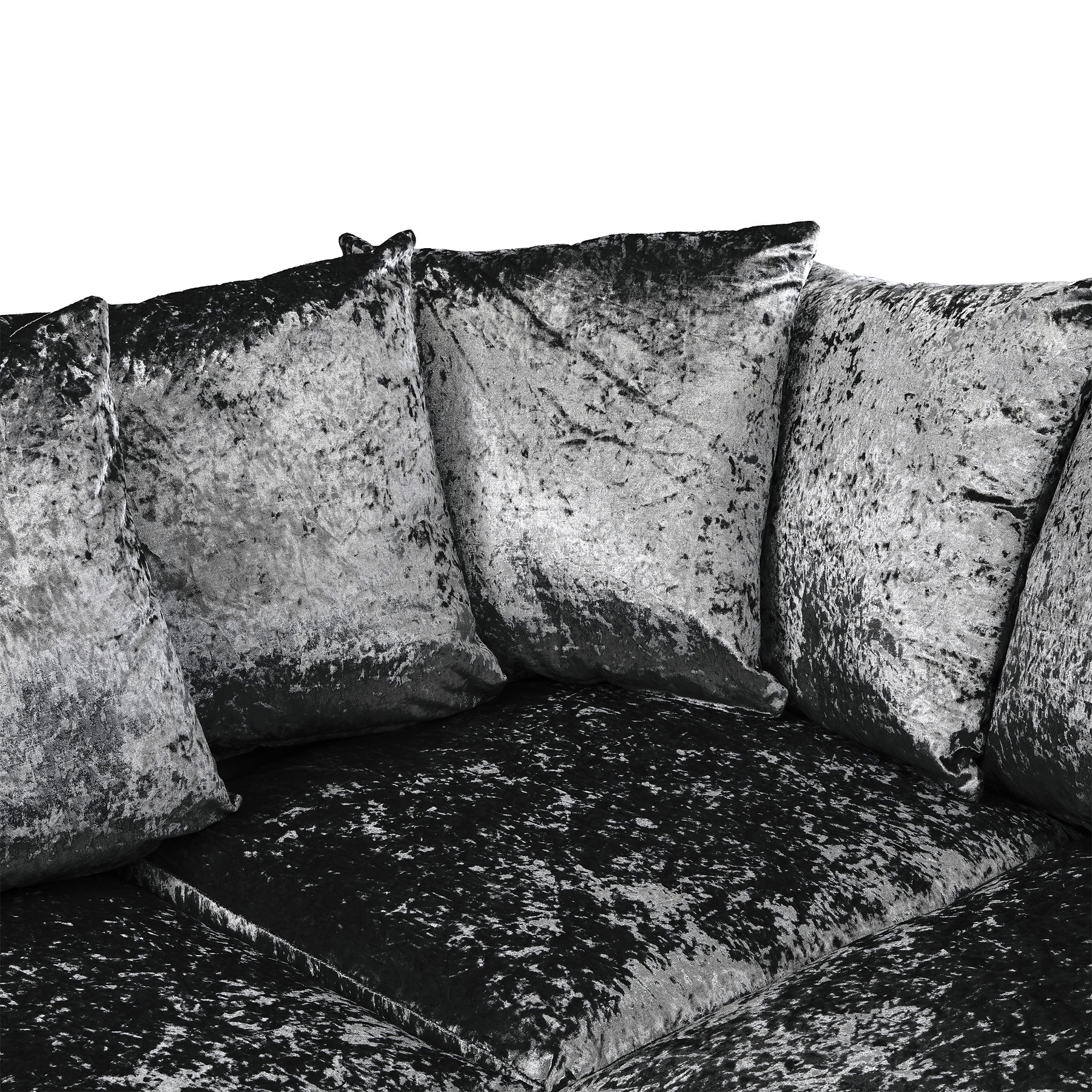 Three velvet cushions resting against each other on a matching dark, textured couch. The image is in grayscale.