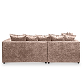 A plush, crushed velvet sofa with multiple cushions against a plain, neutral background.