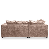A plush, crushed velvet sofa with multiple cushions against a plain, neutral background.